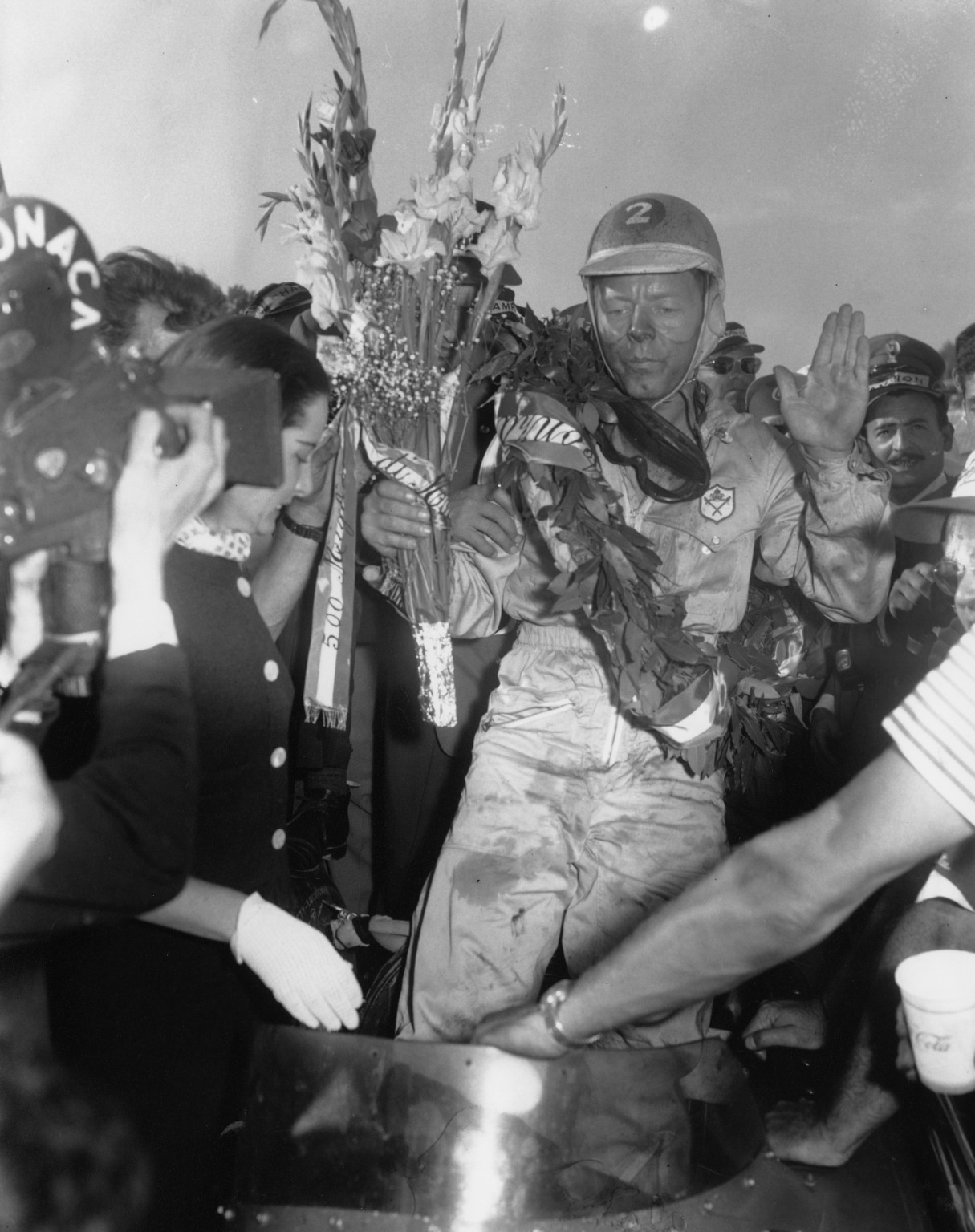 Jim Rathmann of Miami, Fla., holds up a hand after winning the 500-mile Monza road race